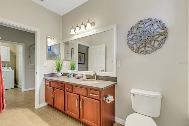 bathroom with washer / clothes dryer, tile patterned flooring, vanity, and toilet