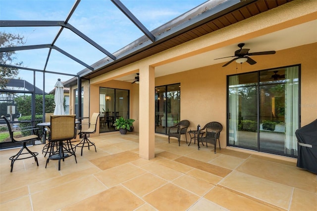 view of patio / terrace featuring glass enclosure and ceiling fan