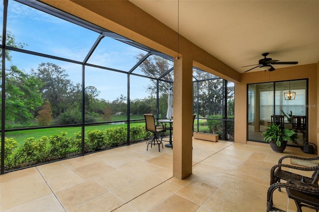 sunroom / solarium featuring ceiling fan