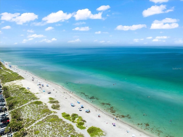 drone / aerial view featuring a beach view and a water view