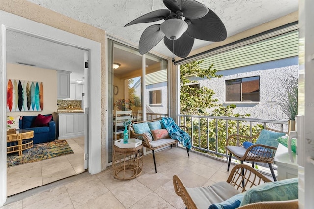 sunroom featuring ceiling fan