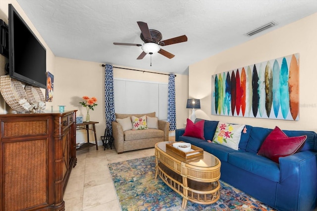 tiled living room featuring ceiling fan