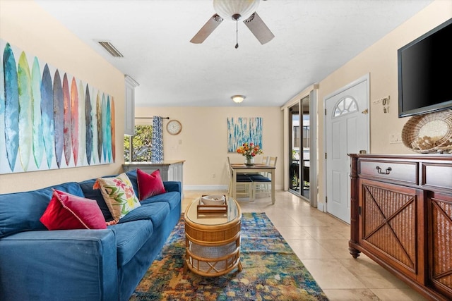 living room with ceiling fan, light tile patterned floors, and a wealth of natural light