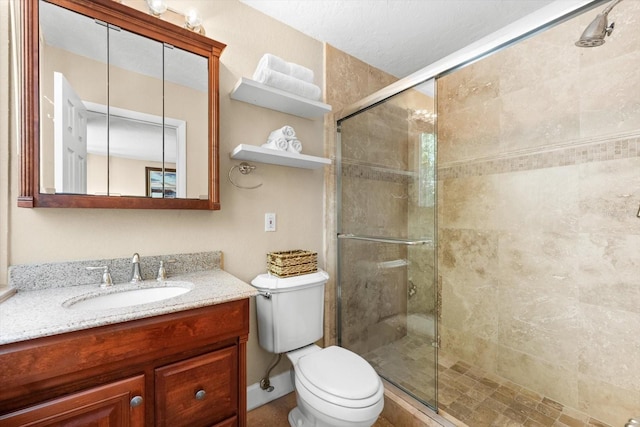 bathroom featuring vanity, toilet, and walk in shower