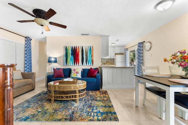 tiled living room featuring ceiling fan