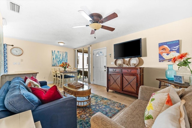 tiled living room with ceiling fan