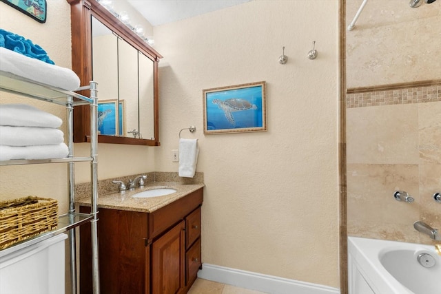 full bathroom featuring toilet, vanity, and tiled shower / bath