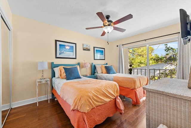 bedroom with a closet, ceiling fan, and dark hardwood / wood-style flooring