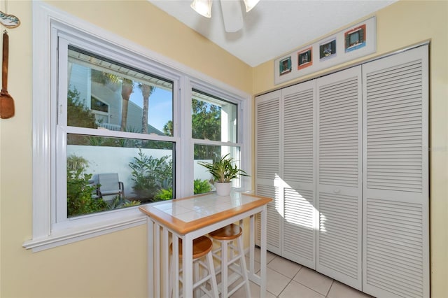 interior space with ceiling fan and a textured ceiling