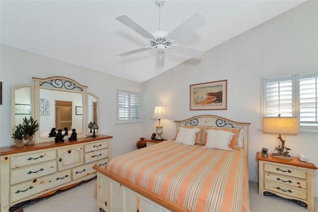 carpeted bedroom with ceiling fan and lofted ceiling