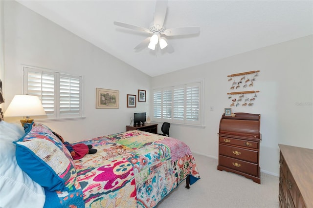 bedroom with multiple windows, light carpet, ceiling fan, and lofted ceiling