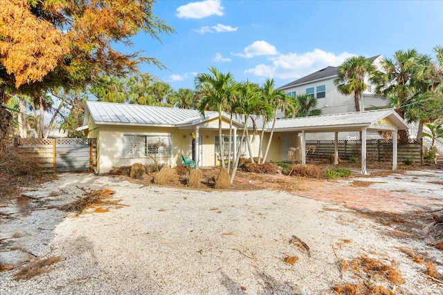 view of front of property featuring a carport