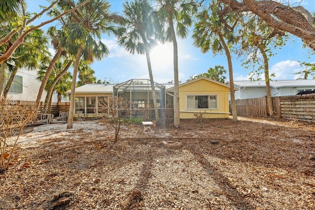 back of property featuring glass enclosure