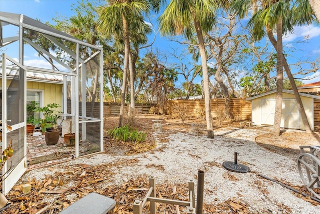 view of yard featuring a shed and a lanai