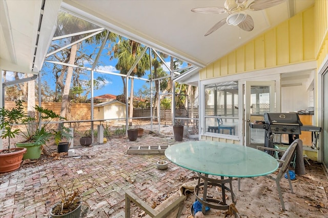 sunroom / solarium featuring ceiling fan and vaulted ceiling