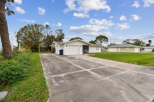 ranch-style home featuring a garage and a front lawn