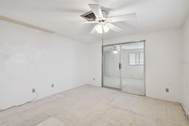 unfurnished bedroom featuring a closet, ceiling fan, and light colored carpet