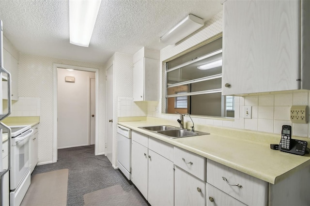 kitchen featuring dark carpet, white appliances, backsplash, sink, and white cabinetry