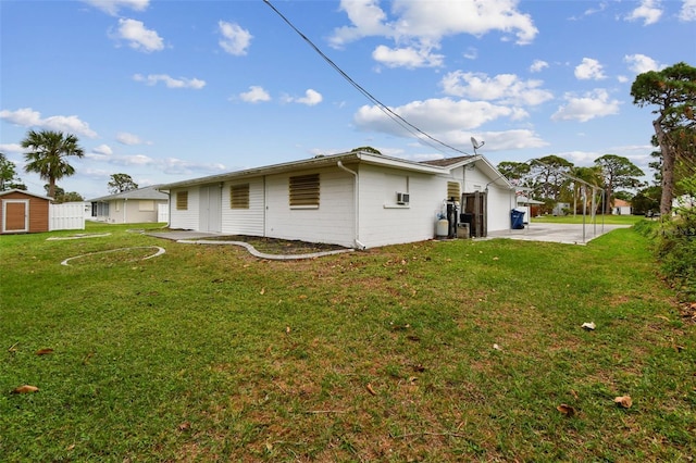 back of house featuring a yard and a patio area