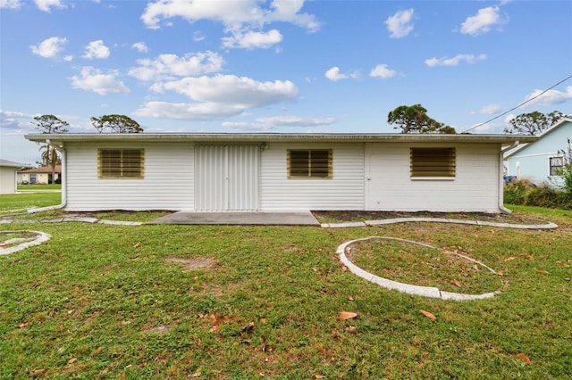 back of property with a patio area and a lawn