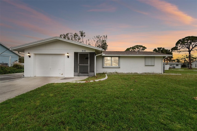 ranch-style house with a lawn and a garage