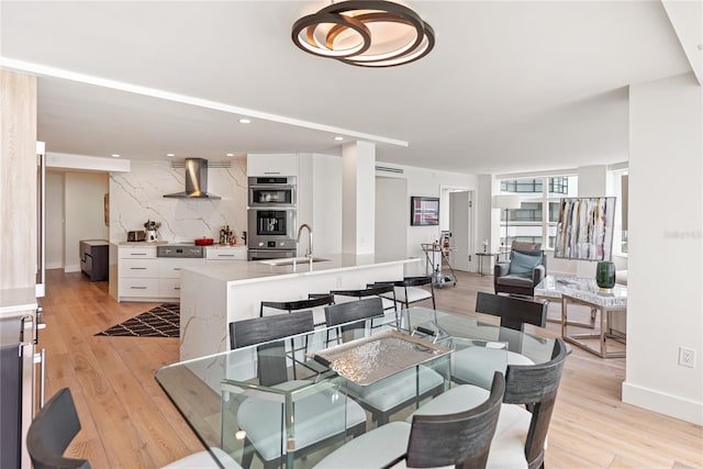 dining area with sink and light hardwood / wood-style flooring