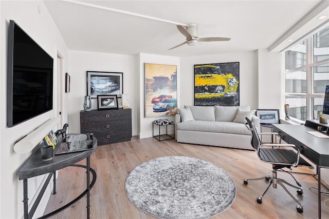 home office with hardwood / wood-style floors and ceiling fan