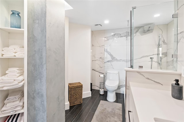 888 Blvd Of The Arts Unit 1705, Sarasota, FL 34236 - bathroom featuring vanity, toilet, a marble finish shower, wood finished floors, and recessed lighting