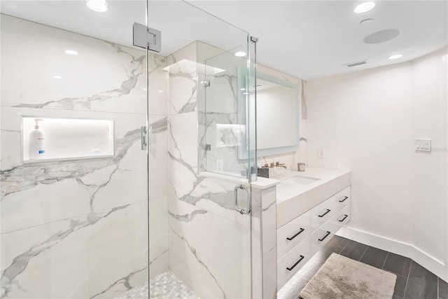 bathroom featuring vanity and an enclosed shower