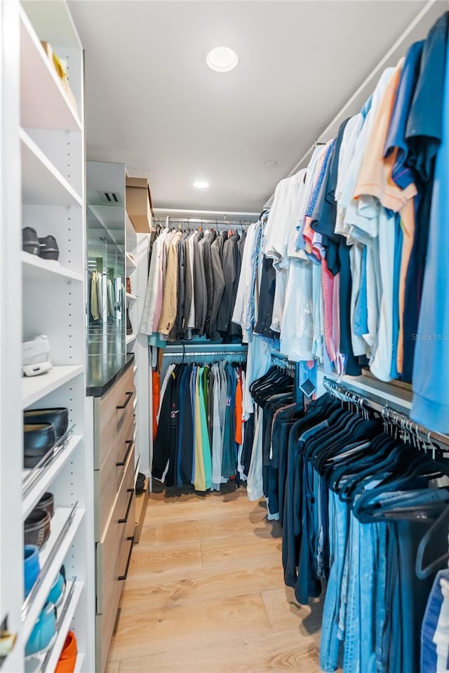 walk in closet with light wood-type flooring