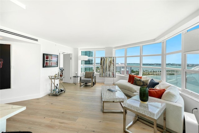 888 Blvd Of The Arts Unit 1705, Sarasota, FL 34236 - living room with light wood finished floors, baseboards, and a water view