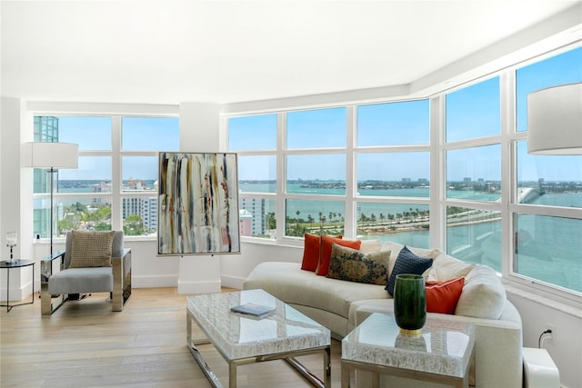 sunroom featuring a water view and a healthy amount of sunlight