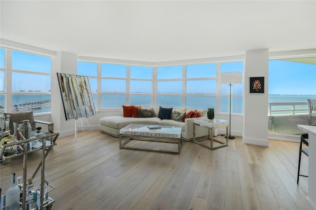 sunroom featuring a water view