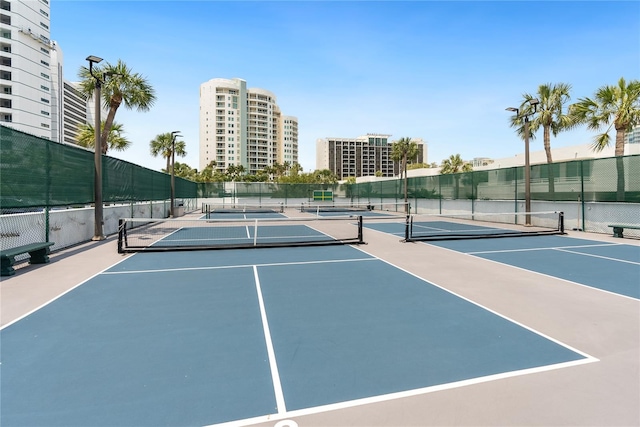 view of tennis court featuring basketball hoop