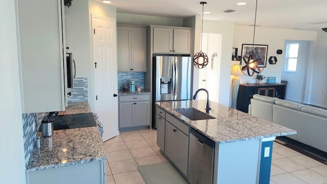 kitchen featuring visible vents, appliances with stainless steel finishes, gray cabinetry, a sink, and light tile patterned flooring