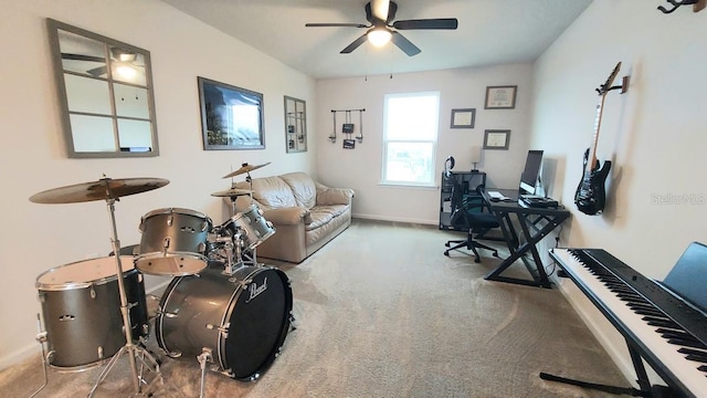 home office featuring carpet, ceiling fan, and baseboards