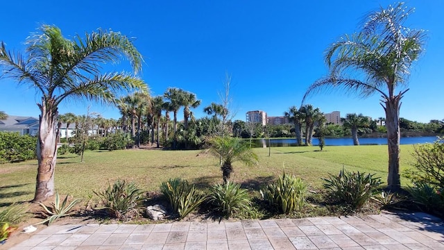 view of property's community featuring a yard and a water view