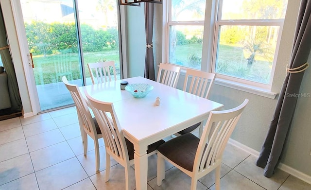 dining room featuring baseboards and light tile patterned floors