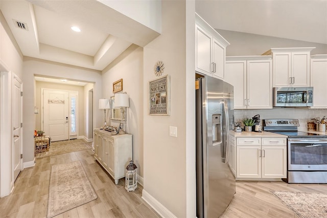 14924 Sora Way, Bradenton, FL 34212 - kitchen with appliances with stainless steel finishes, white cabinetry, light wood-type flooring, backsplash, and baseboards