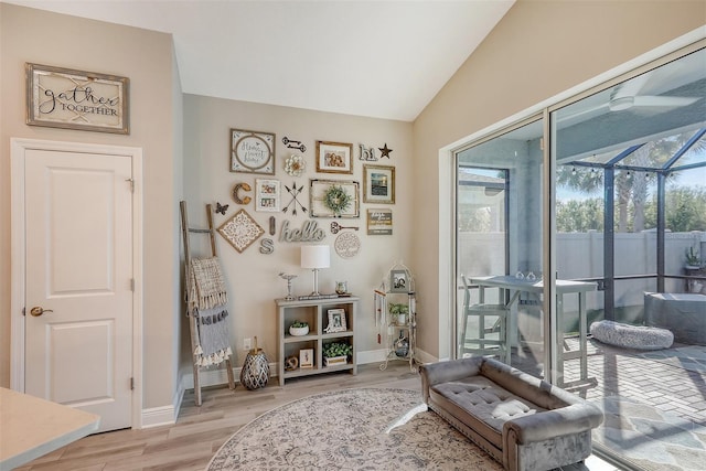 sitting room with vaulted ceiling and light hardwood / wood-style flooring