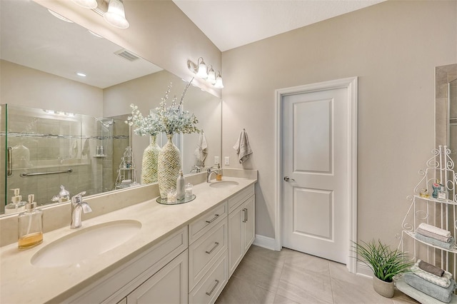 bathroom featuring tiled shower, vanity, and tile patterned floors