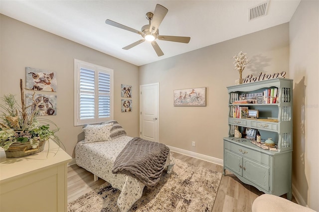 bedroom with light hardwood / wood-style floors and ceiling fan