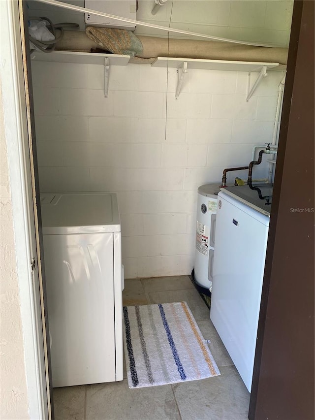 washroom with independent washer and dryer and water heater