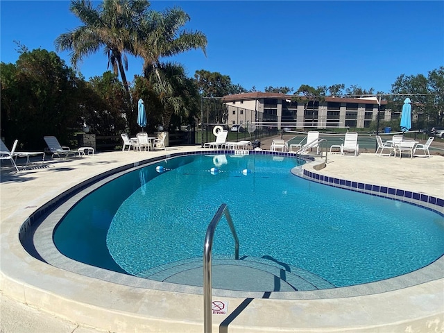 view of swimming pool with a patio area