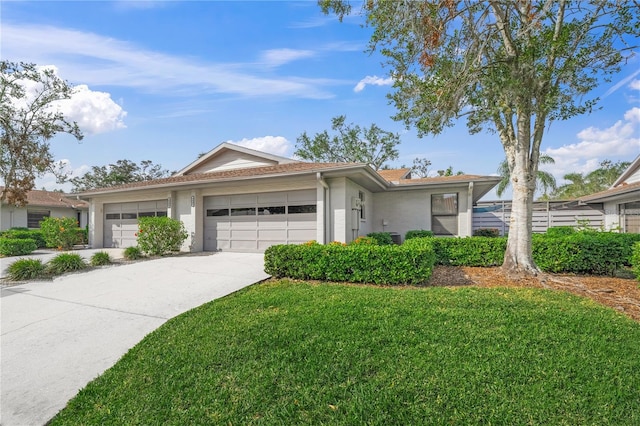 ranch-style house featuring a front yard and a garage