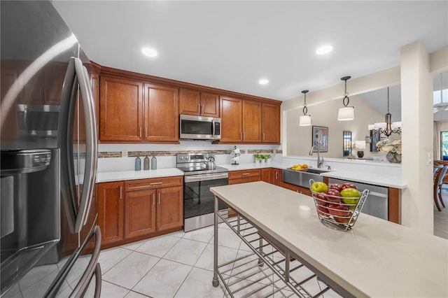 kitchen featuring kitchen peninsula, pendant lighting, vaulted ceiling, a breakfast bar, and appliances with stainless steel finishes