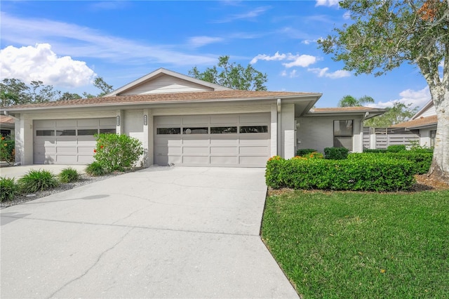 ranch-style home featuring a garage and a front lawn