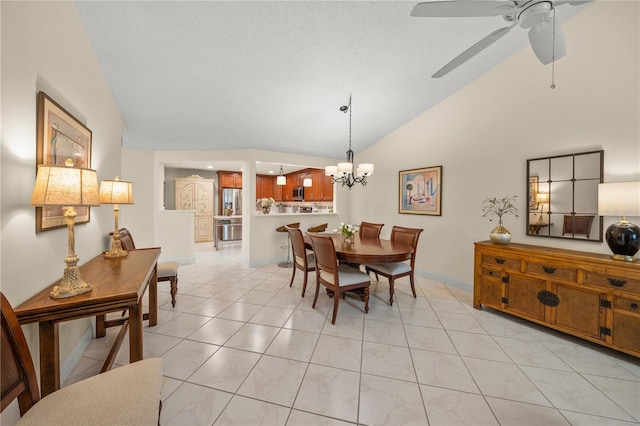 dining room featuring a textured ceiling, ceiling fan with notable chandelier, light tile patterned flooring, and vaulted ceiling