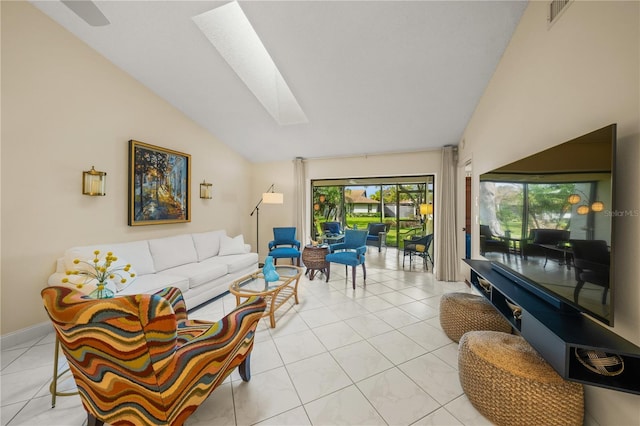 living room featuring vaulted ceiling with skylight and light tile patterned floors