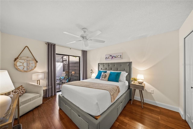 bedroom featuring a textured ceiling, access to exterior, ceiling fan, and dark hardwood / wood-style floors